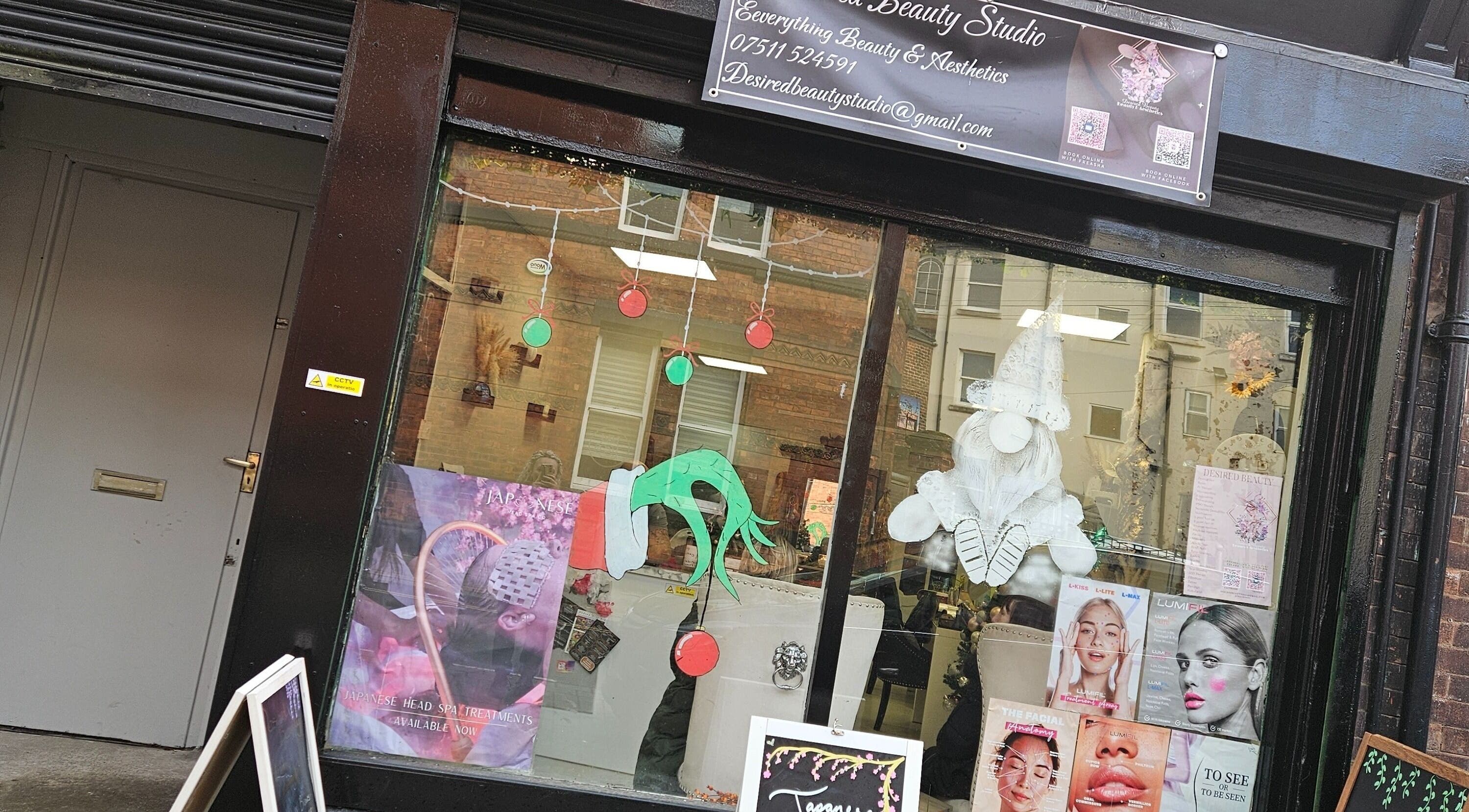 Desired Beauty storefront in St Helens, England, showcasing beauty services and vibrant window decor.