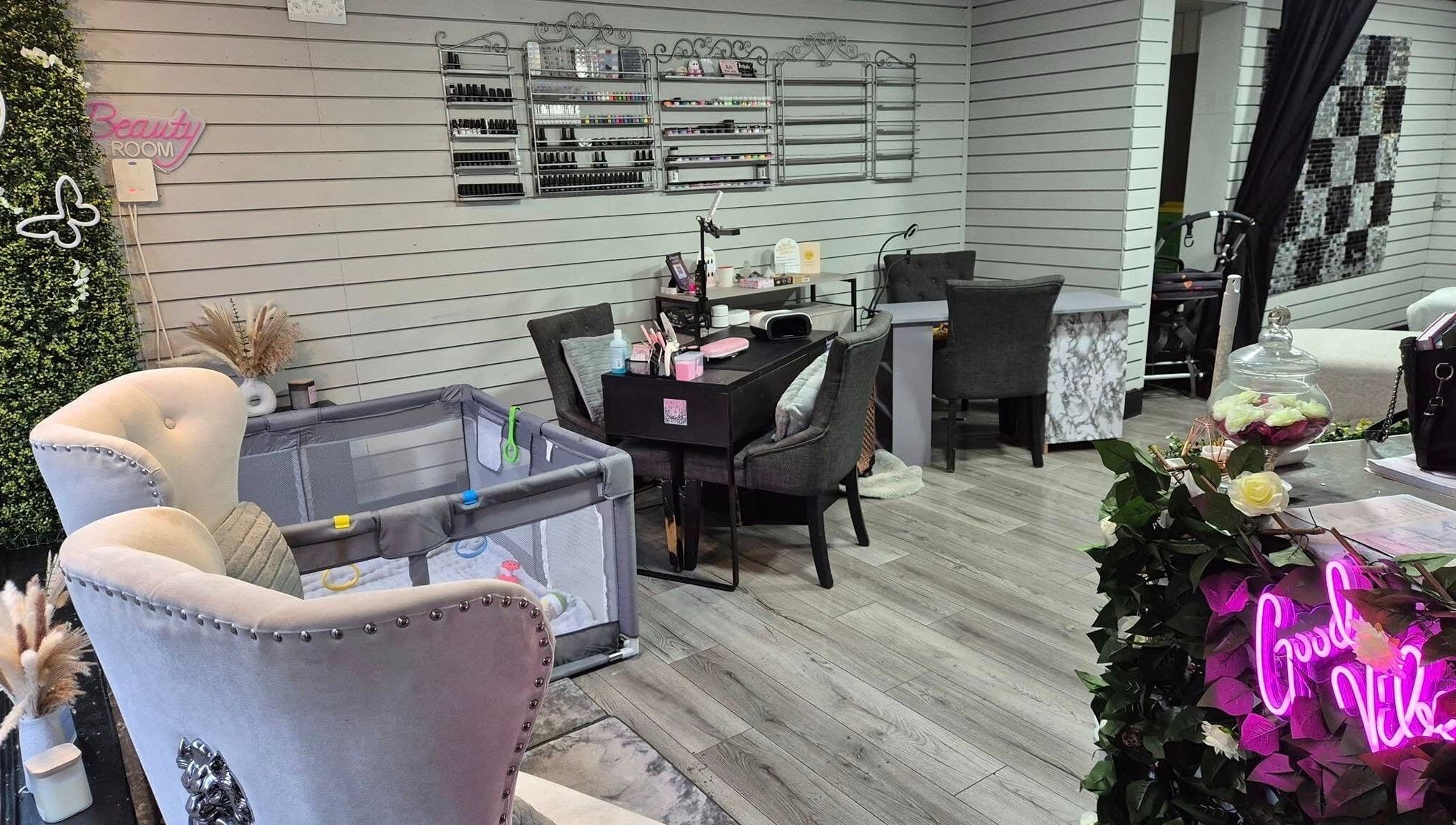 Elegant interior of Desired Beauty salon in St Helens, England, showcasing luxury seating and nail area.
