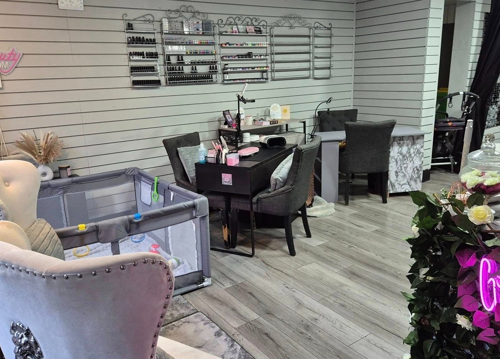 Elegant interior of Desired Beauty salon in St Helens, England, showcasing luxury seating and nail area.
