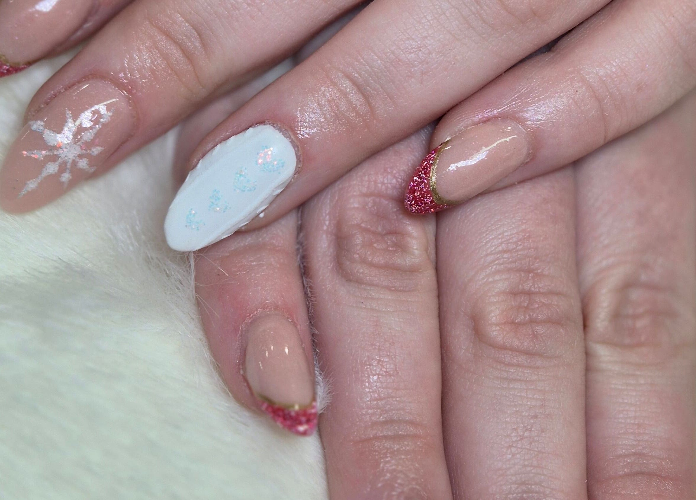 Stunning nail art with snowflakes and glitter tips at Desired Beauty, St Helens, England, GB.