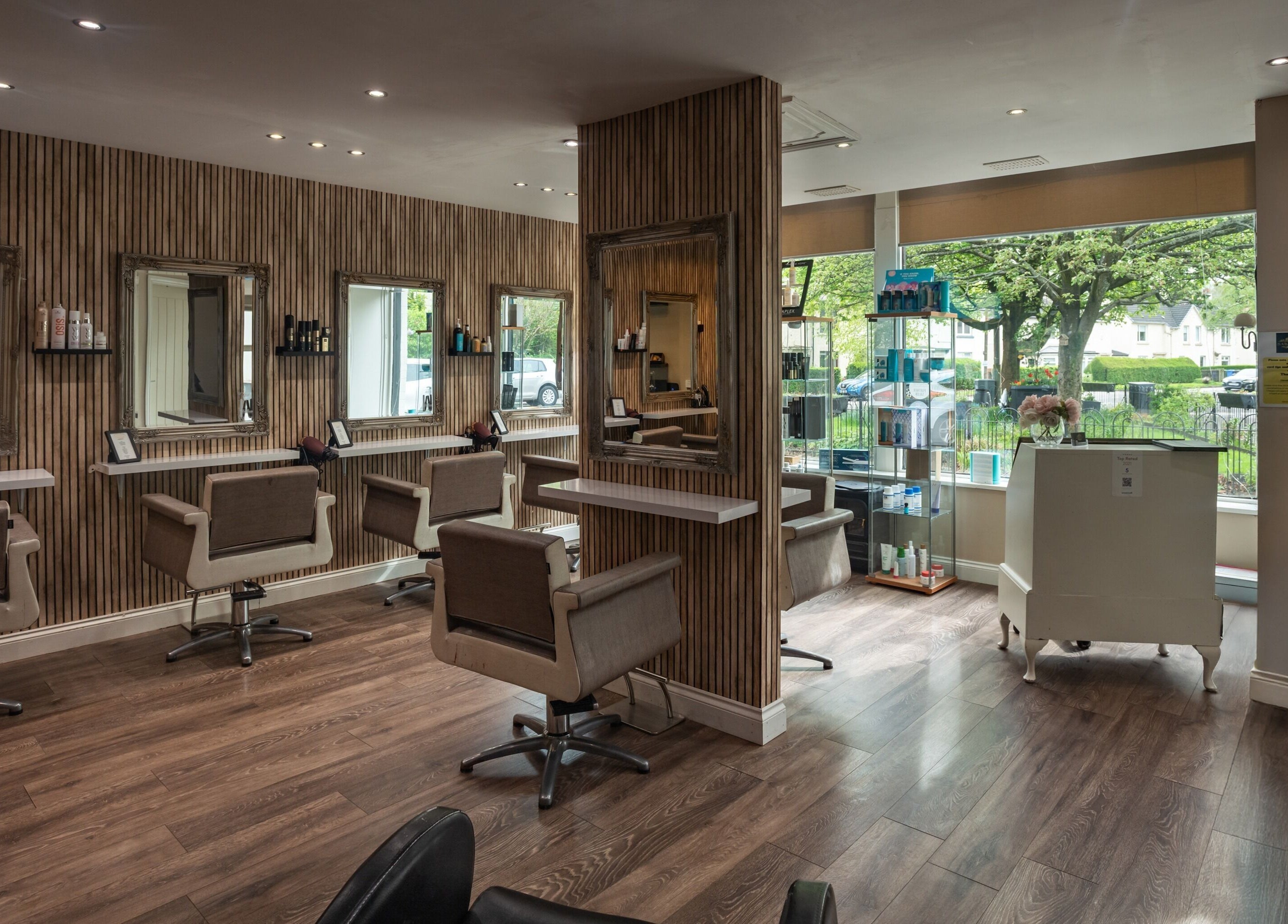 Elegant interior of Salon at No.1 in Glasgow, Scotland, GB with stylish chairs and large mirrors.