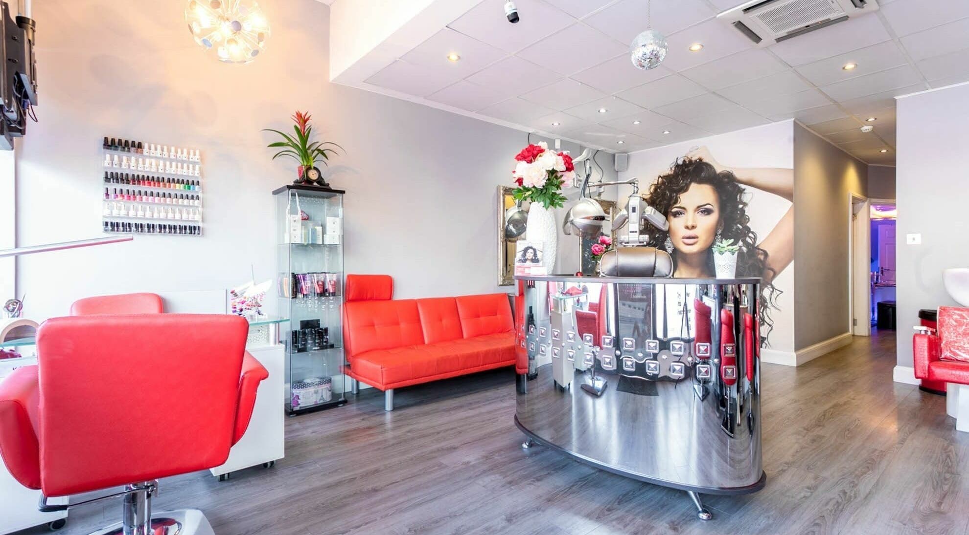 Stylish interior of Mirror Mirror in Greenford, England, GB with vibrant red seating and modern decor.
