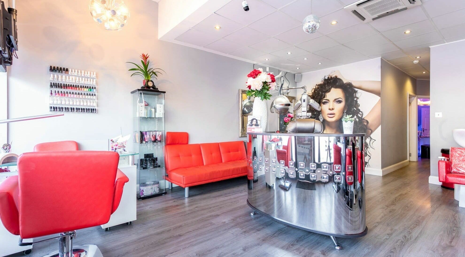 Stylish interior of Mirror Mirror in Greenford, England, GB with vibrant red seating and modern decor.