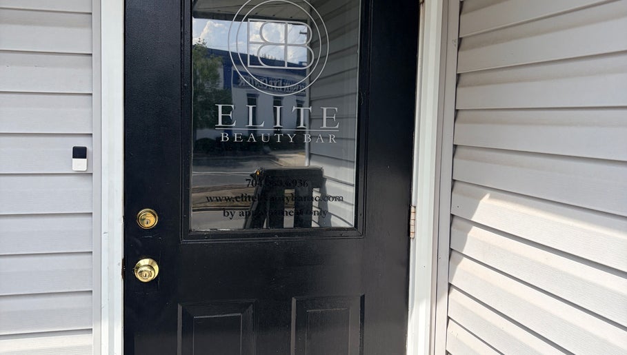 Door of Too Prissy Beauty in Concord, North Carolina, US, showcasing a sleek black design.