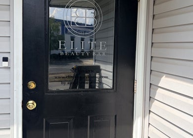 Door of Too Prissy Beauty in Concord, North Carolina, US, showcasing a sleek black design.
