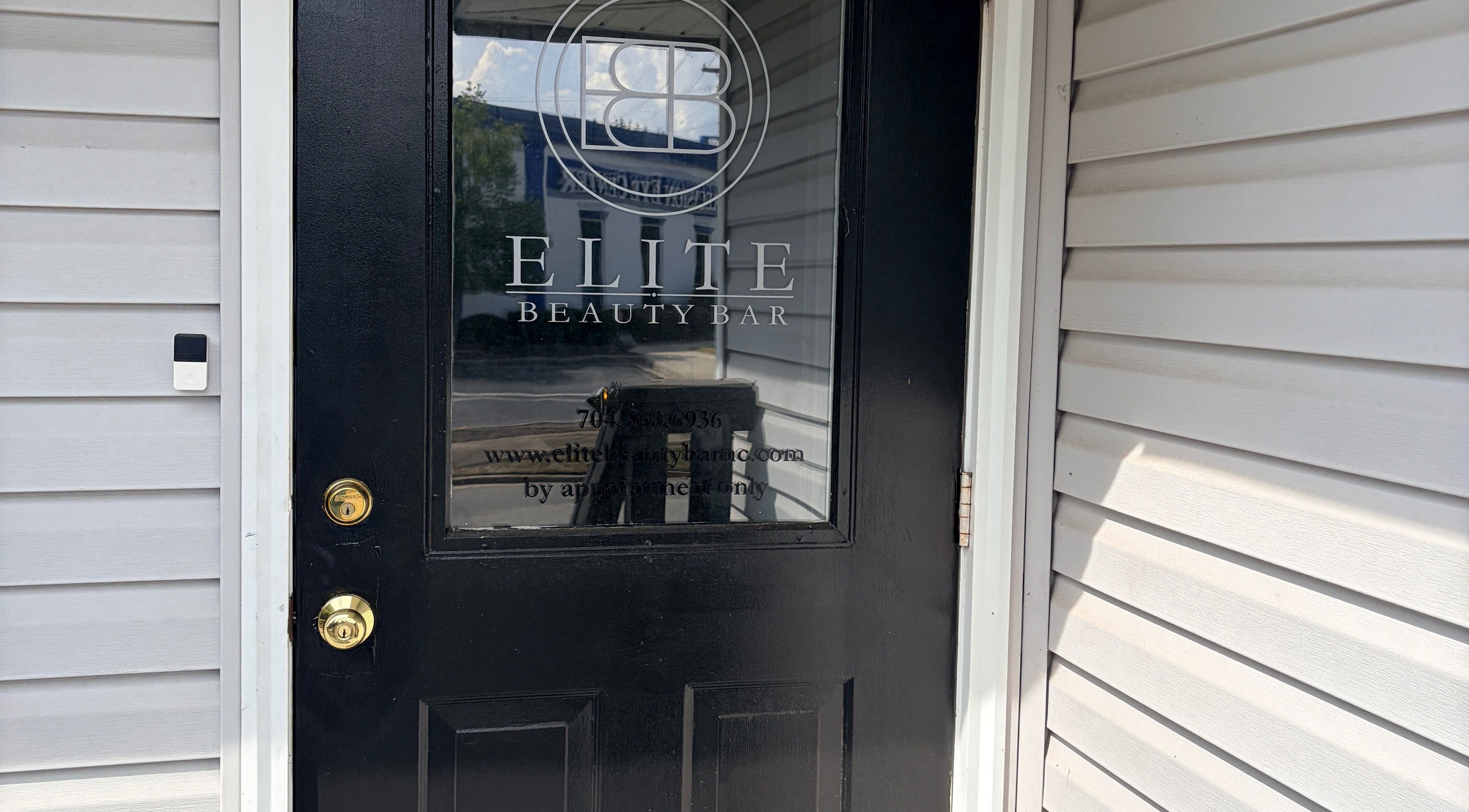 Door of Too Prissy Beauty in Concord, North Carolina, US, showcasing a sleek black design.