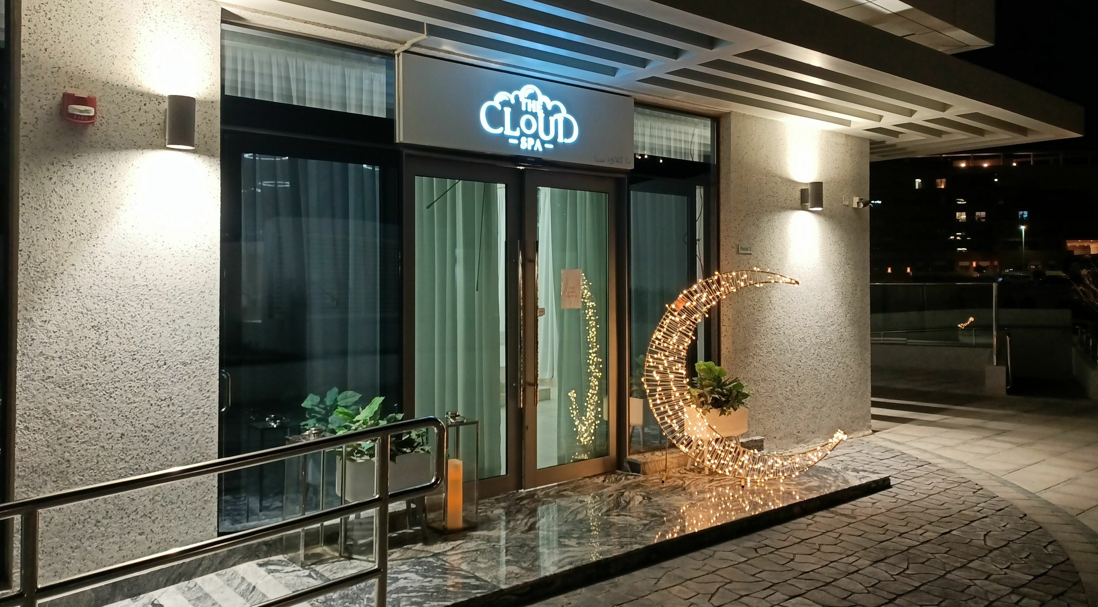 Elegant entrance of The Cloud Spa in Abu Dhabi, AE, featuring a glowing crescent sculpture and modern design.