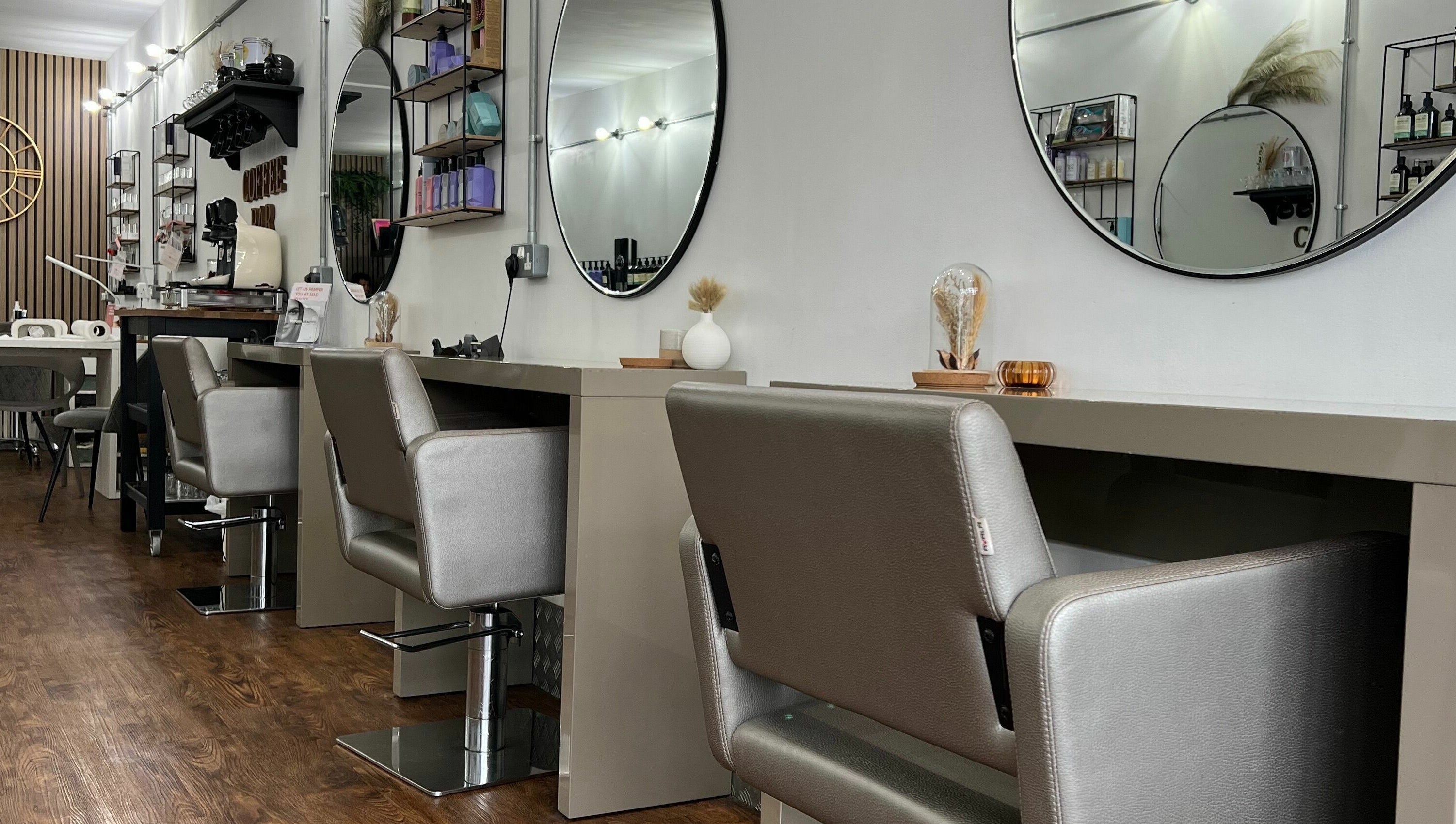 Modern styling chairs and mirrors at Makeover Salon in Derby, England, GB, showcasing elegant interiors.