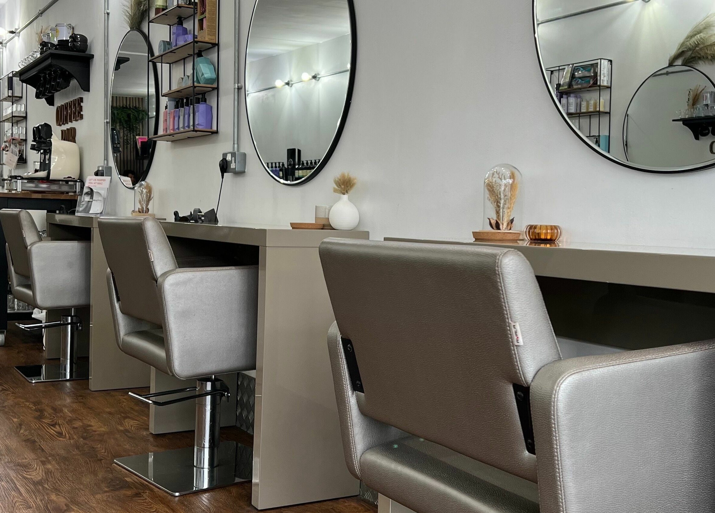 Modern styling chairs and mirrors at Makeover Salon in Derby, England, GB, showcasing elegant interiors.