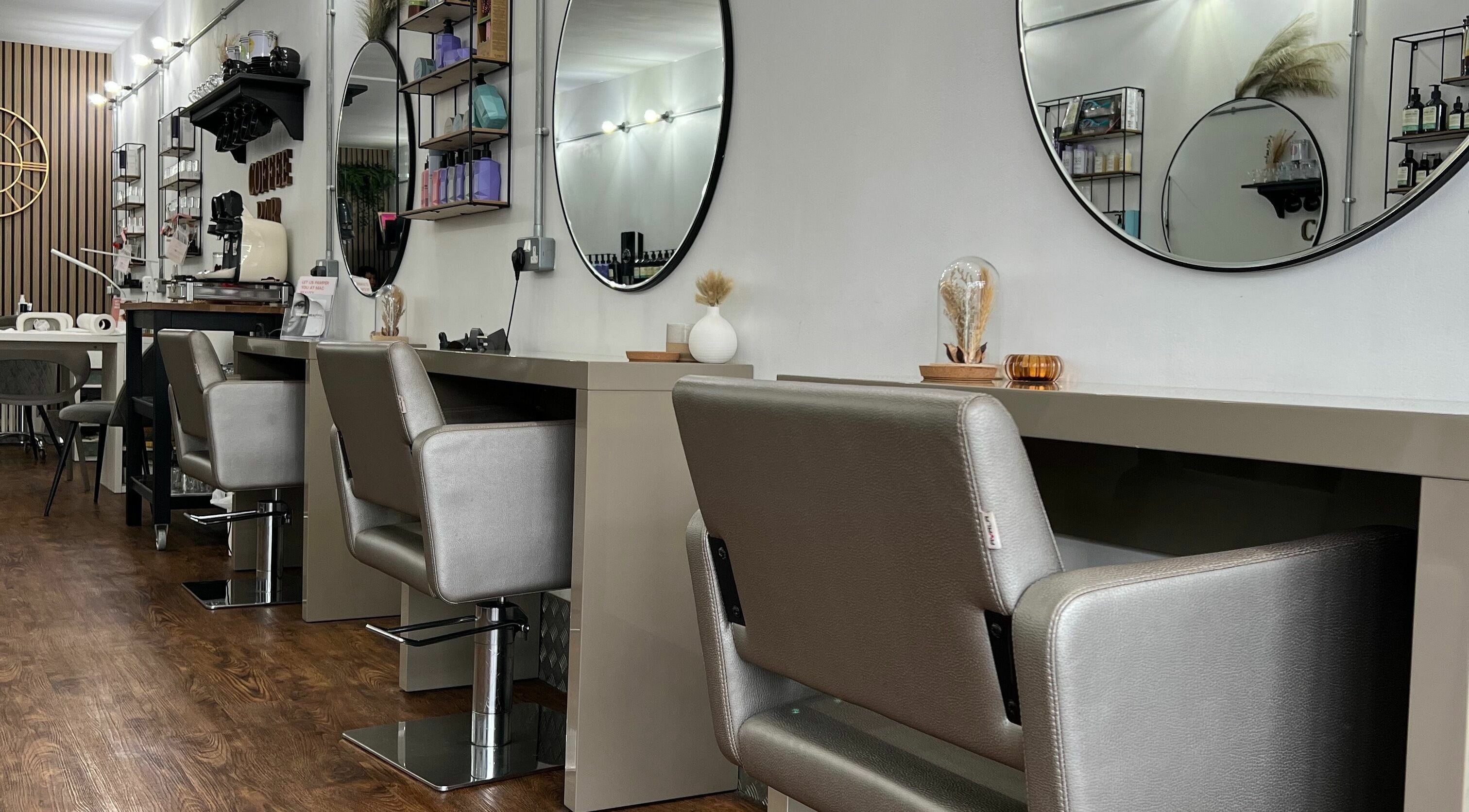 Modern styling chairs and mirrors at Makeover Salon in Derby, England, GB, showcasing elegant interiors.