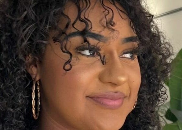 Woman with stunning curls at Makeover Salon, Derby, England, GB, showcasing natural beauty and style.