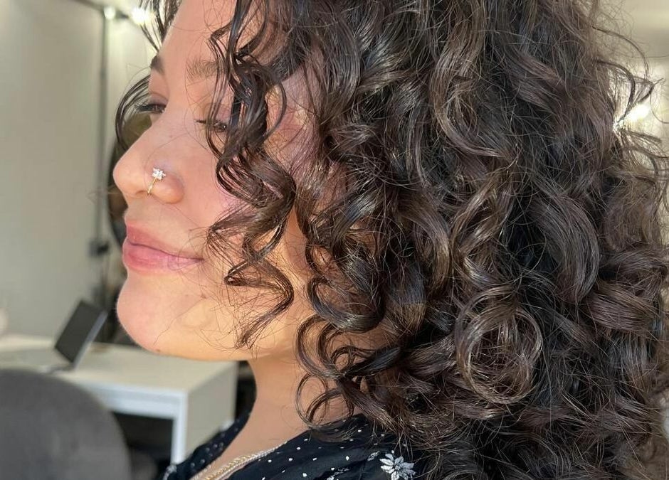 Close-up of styled curly hair at Makeover Salon, Derby, England, GB, showcasing elegant bouncy curls.