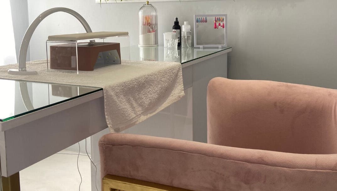 Luxify Laser's chic manicure station in Cape Town, Western Cape, ZA with pink velvet chair and stylish decor.