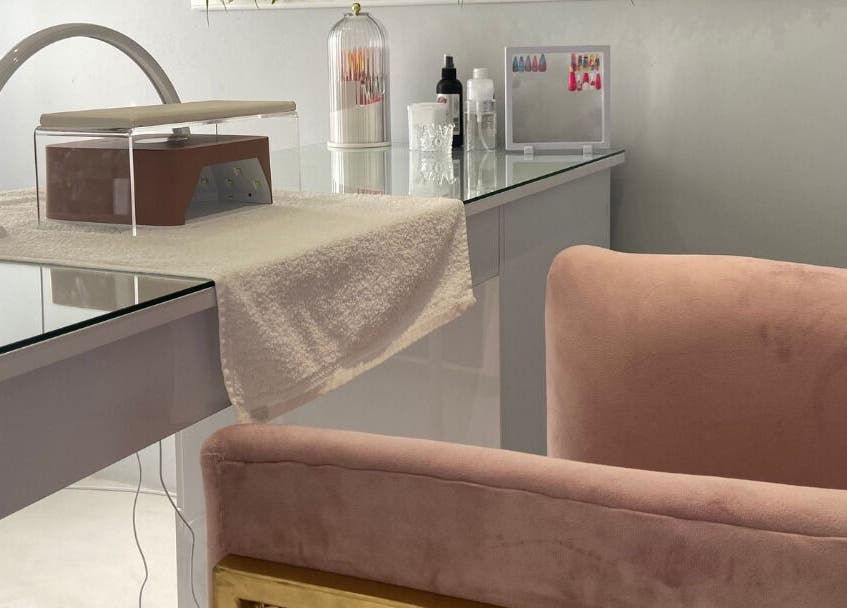 Luxify Laser's chic manicure station in Cape Town, Western Cape, ZA with pink velvet chair and stylish decor.