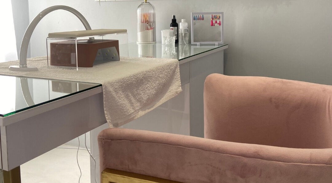 Luxify Laser's chic manicure station in Cape Town, Western Cape, ZA with pink velvet chair and stylish decor.