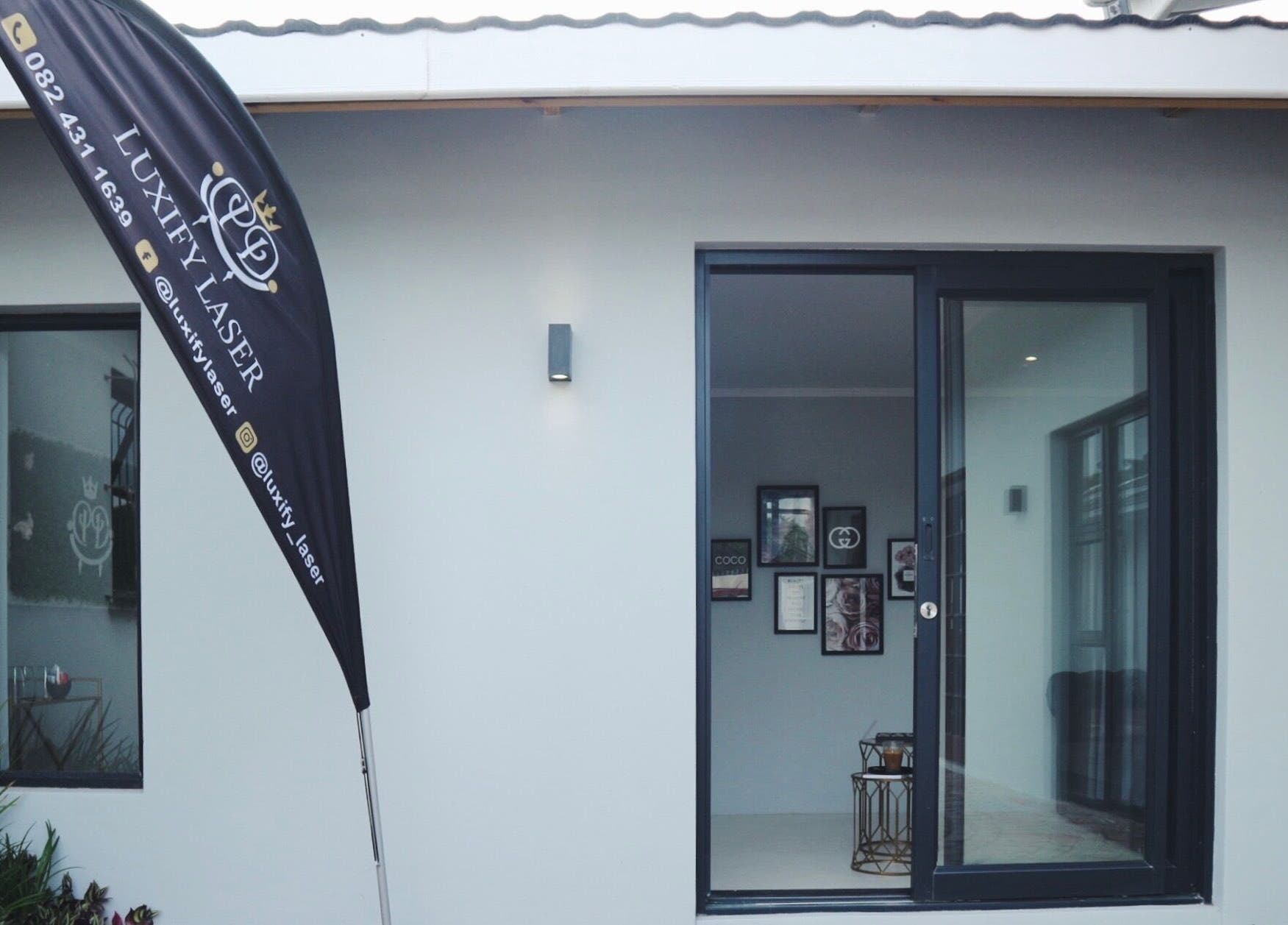 Front view of Luxify Laser in Cape Town, Western Cape, ZA with banner and entrance.