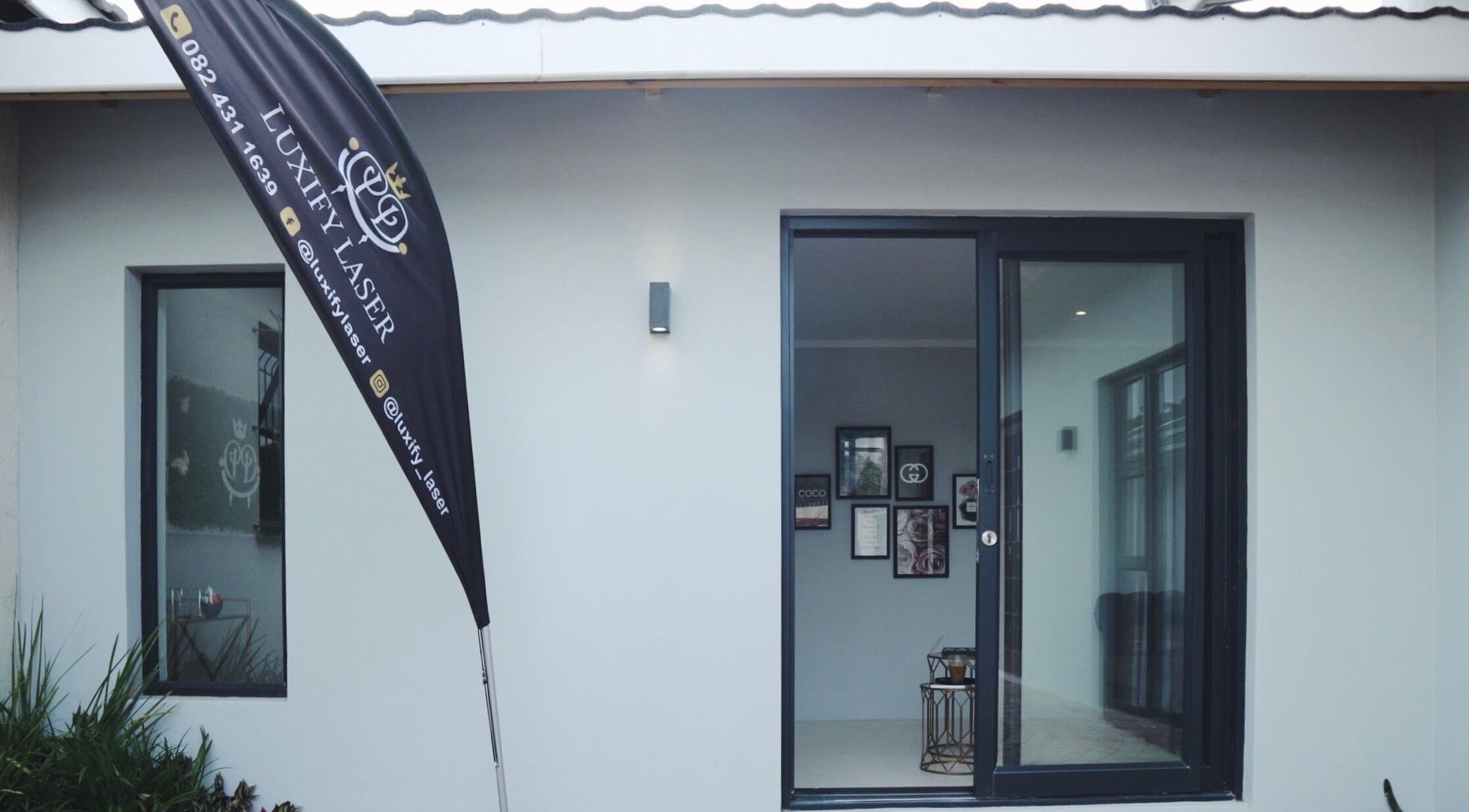 Front view of Luxify Laser in Cape Town, Western Cape, ZA with banner and entrance.