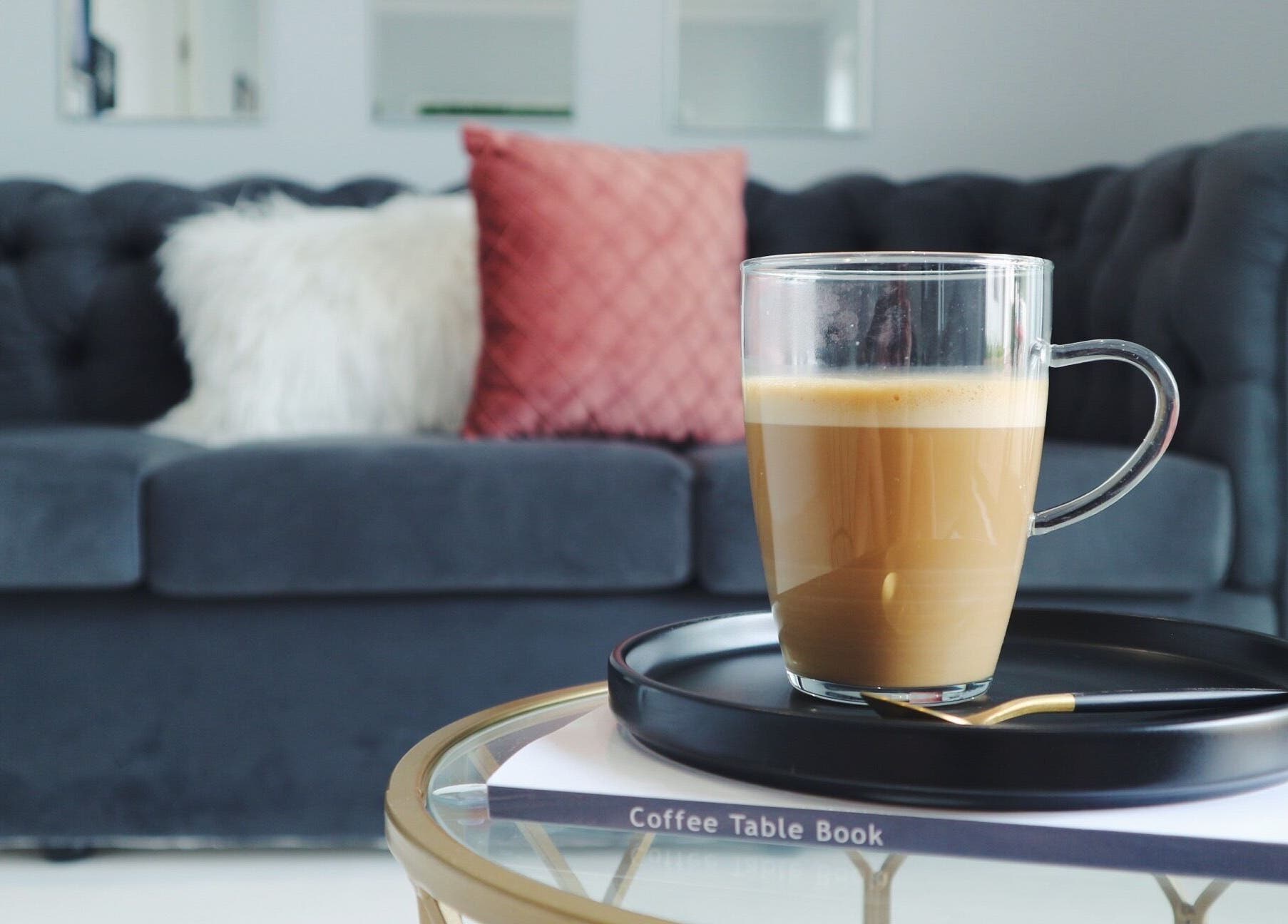 Luxify Laser's elegant waiting area in Cape Town, Western Cape, ZA with plush sofa and coffee table.