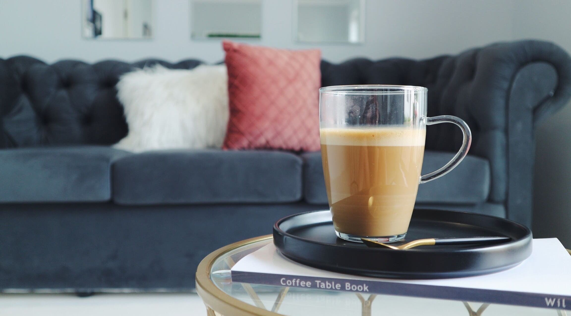 Luxify Laser's elegant waiting area in Cape Town, Western Cape, ZA with plush sofa and coffee table.