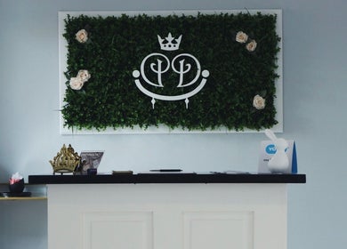 Luxify Laser reception with green foliage and sleek decor at Cape Town, Western Cape, ZA.