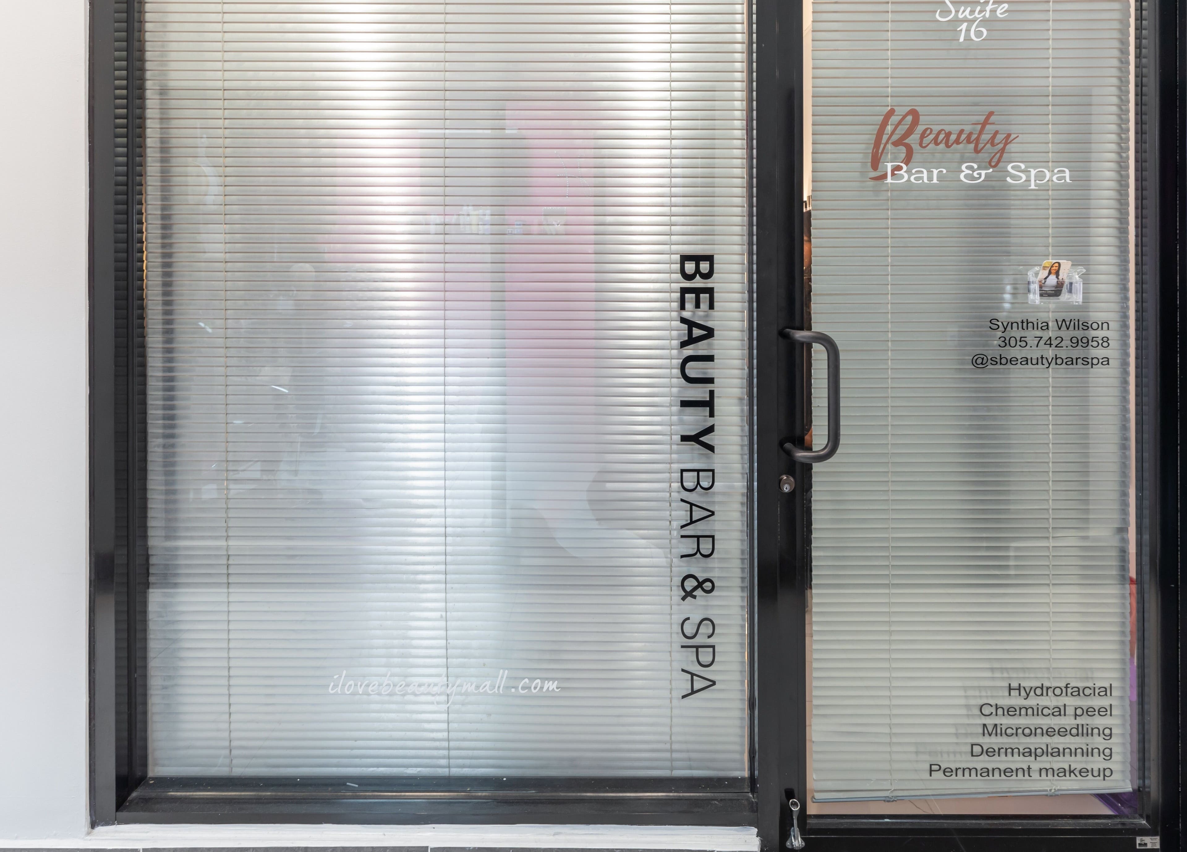Entrance of Beauty Bar & Spa in Miramar, Florida with glass doors displaying services offered.
