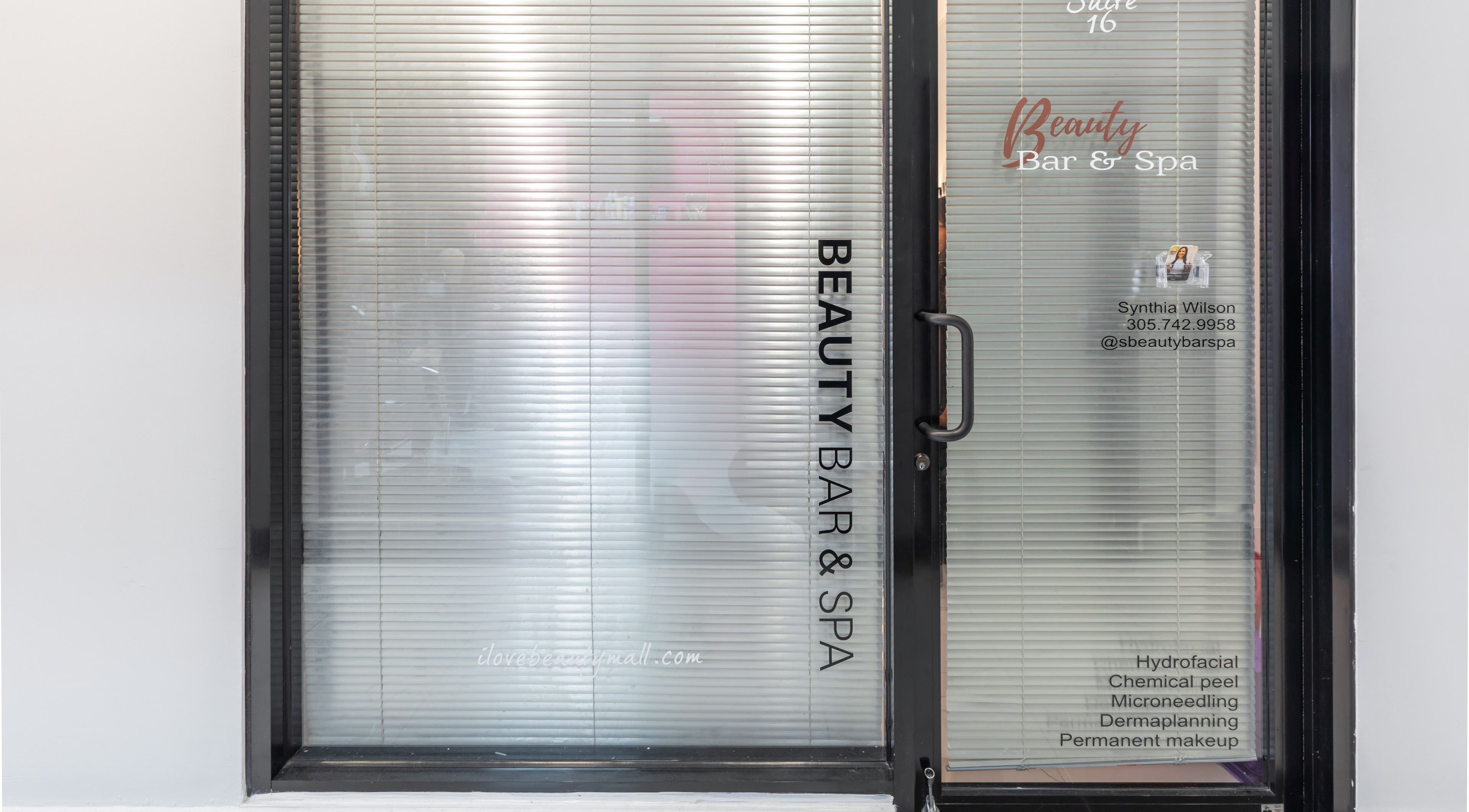 Entrance of Beauty Bar & Spa in Miramar, Florida with glass doors displaying services offered.