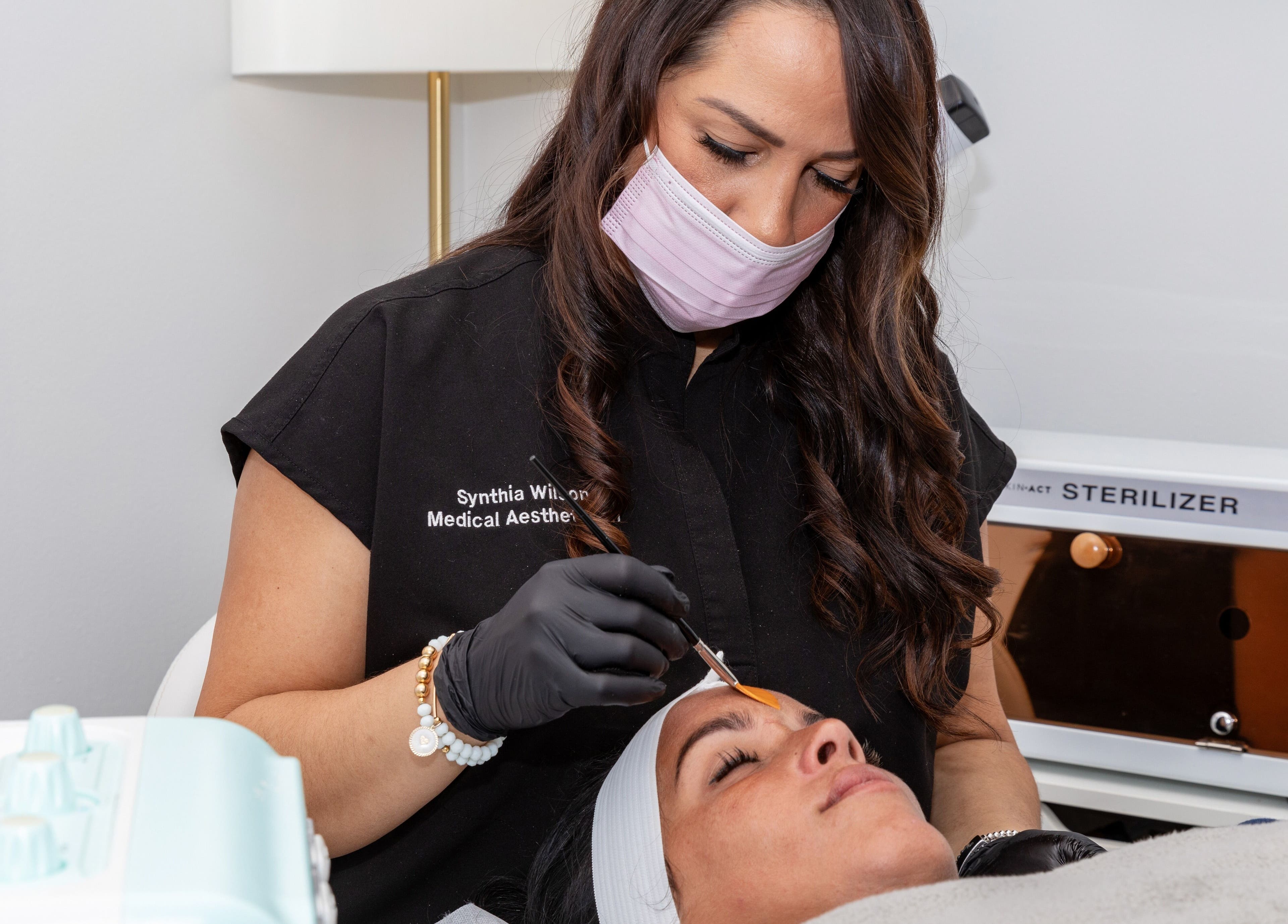 Aesthetician performing treatment at Beauty Bar & Spa, Miramar, Florida, US, creating a rejuvenating experience.