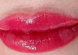 Glossy red lips showcased at Vy Brows Academy in Houston, Texas, US, highlighting expert beauty services.