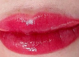 Glossy red lips showcased at Vy Brows Academy in Houston, Texas, US, highlighting expert beauty services.