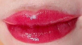 Glossy red lips showcased at Vy Brows Academy in Houston, Texas, US, highlighting expert beauty services.