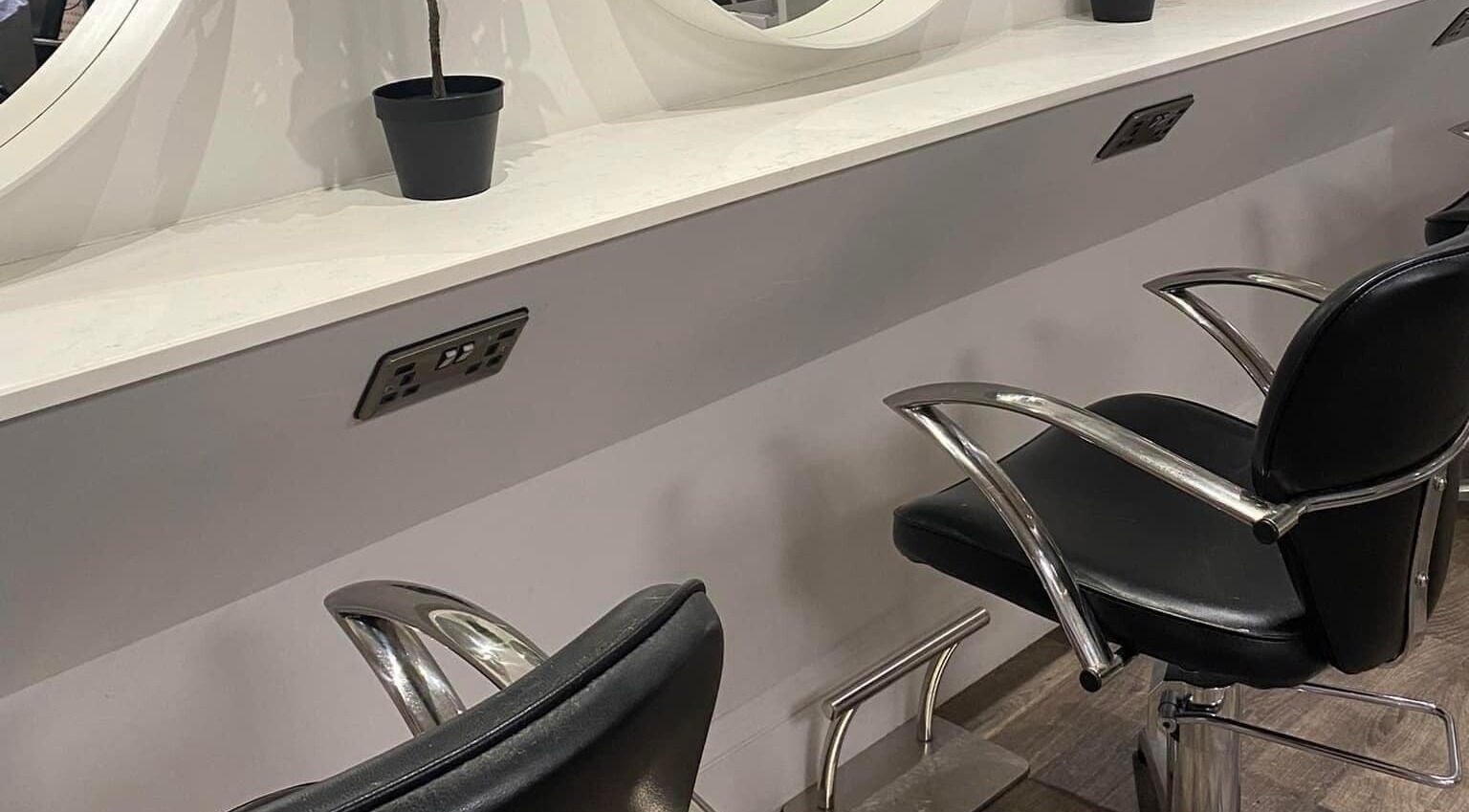 Modern salon styling chairs at Chique Hair & Beauty, Carlisle, England, GB.