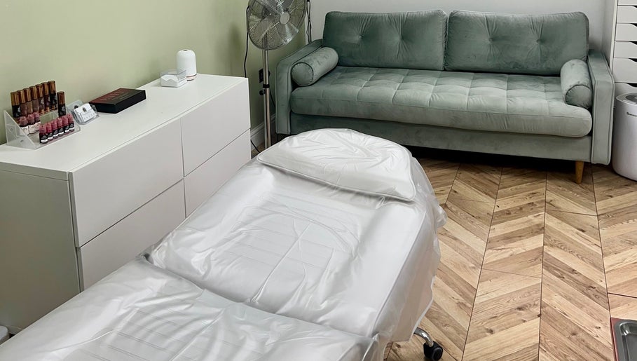 Relaxing treatment room at Arched And Dangerous Aesthetics, Dinas Powys, Wales, GB with a cozy couch.