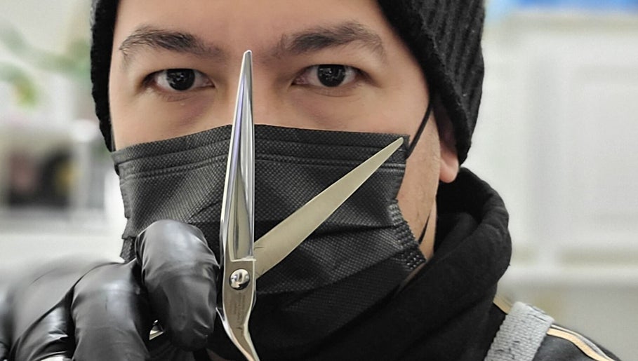 Skilled stylist at Rod Salmone in Surrey, BC, CA with professional scissors poised for expert haircuts.