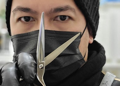 Skilled stylist at Rod Salmone in Surrey, BC, CA with professional scissors poised for expert haircuts.
