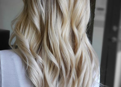 Elegant blonde waves styled at Rod Salmone in Surrey, British Columbia, CA, showcasing expert hair artistry.