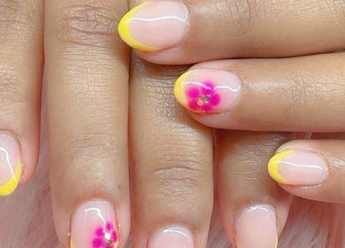 Stylish yellow-tipped nails with flower accents at Beauty with Grace Rolleston, Rolleston, Canterbury, NZ.