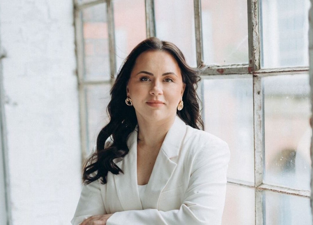 Person standing by large window at Skin Spa Embassy, Northampton, England, GB, exuding calm and confidence.
