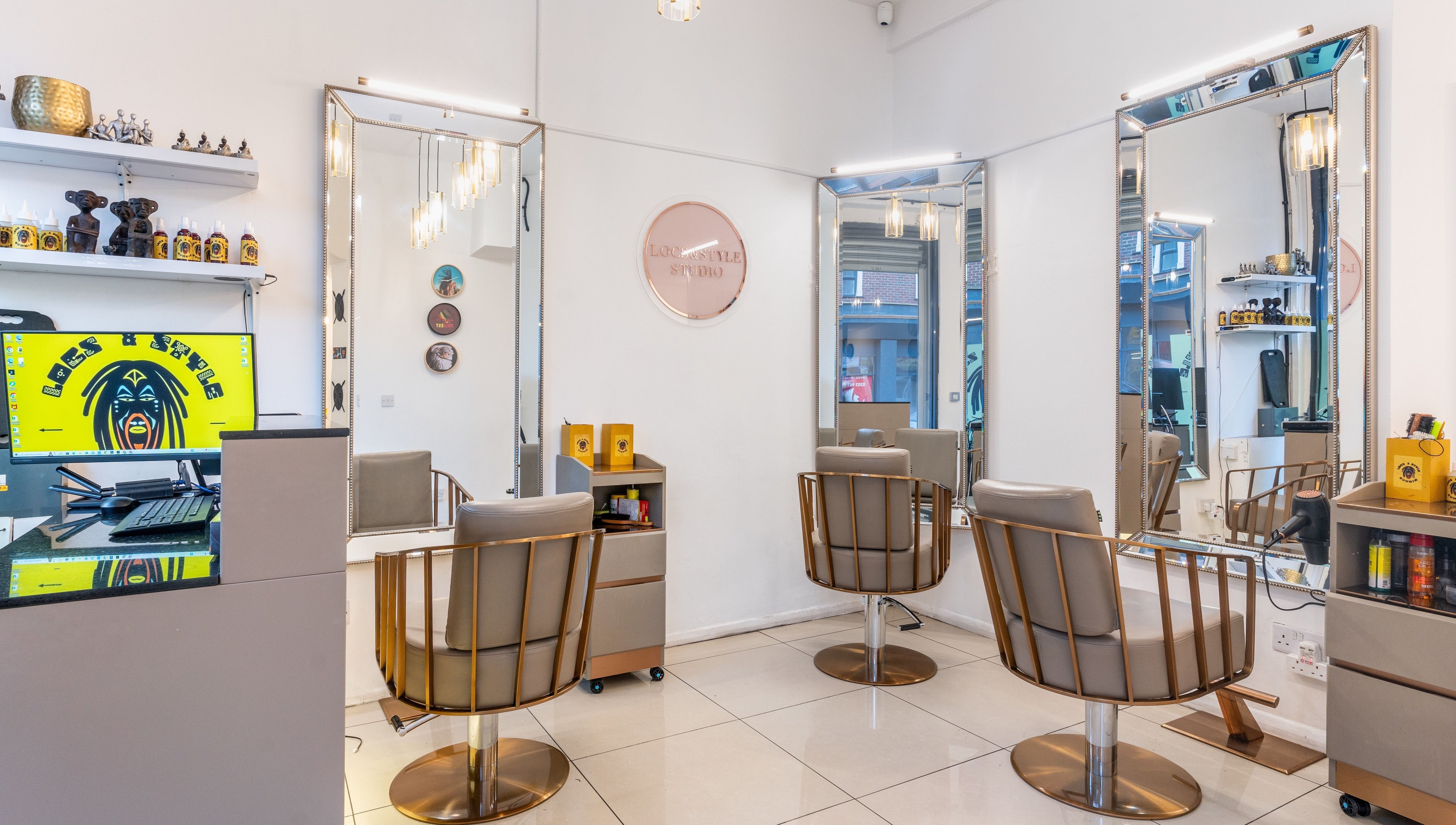 Elegant interior of Locks & Style Studio in London, England, GB, featuring modern chairs and large mirrors.