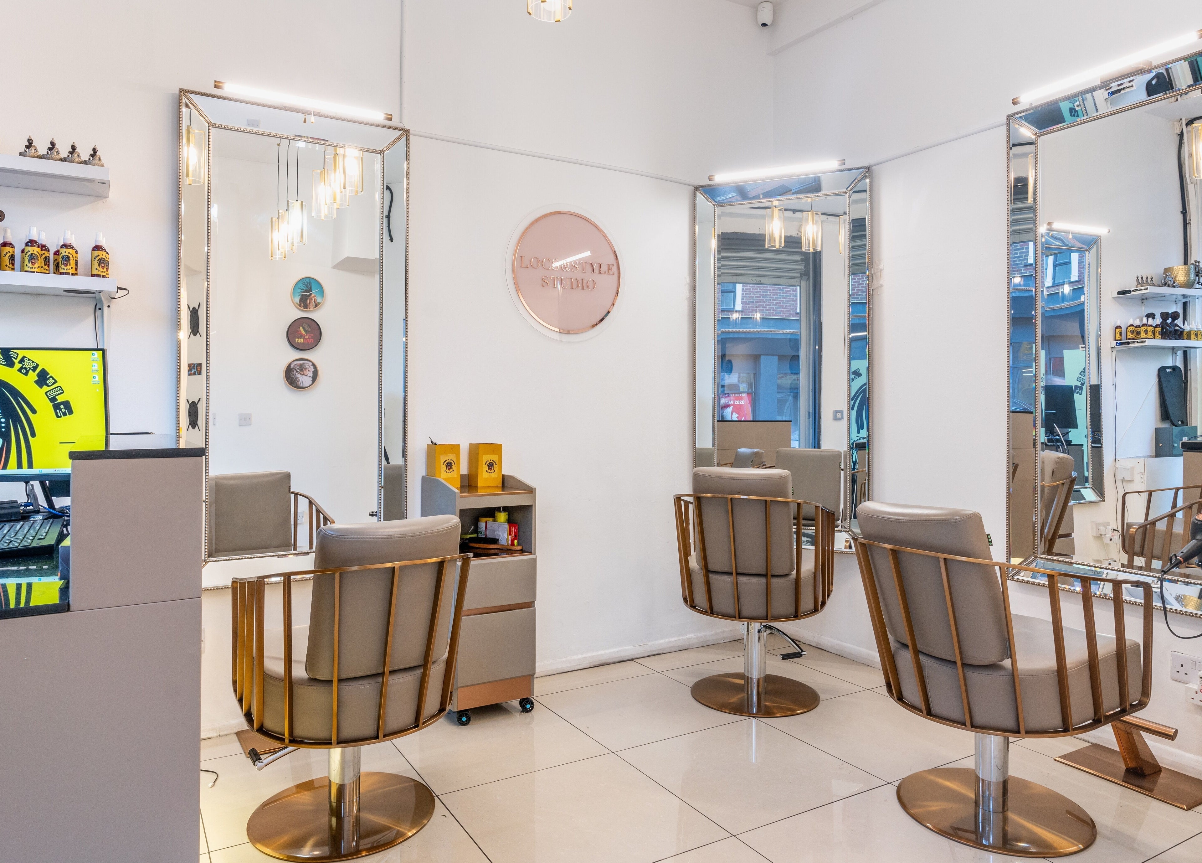 Elegant interior of Locks & Style Studio in London, England, GB, featuring modern chairs and large mirrors.