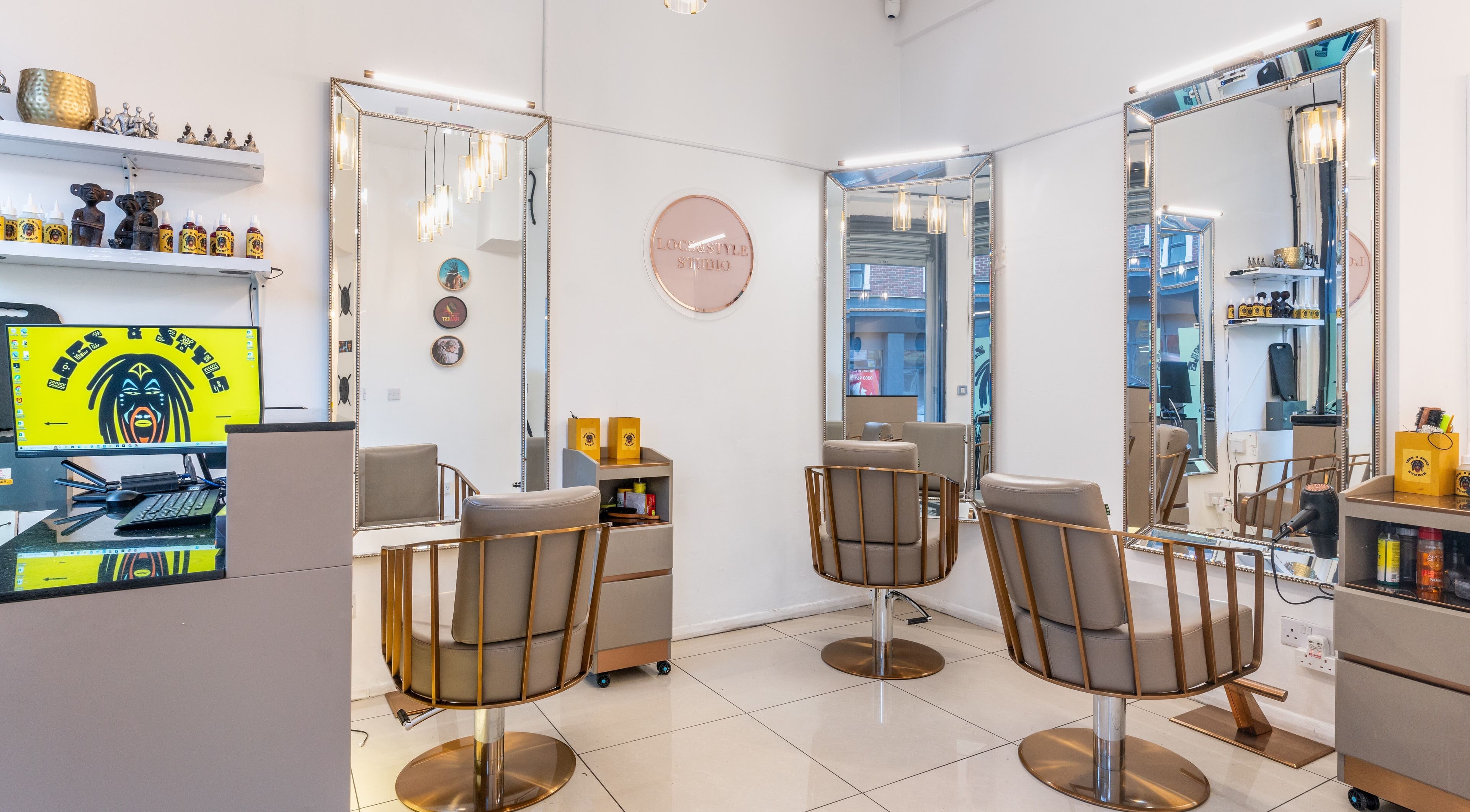 Elegant interior of Locks & Style Studio in London, England, GB, featuring modern chairs and large mirrors.