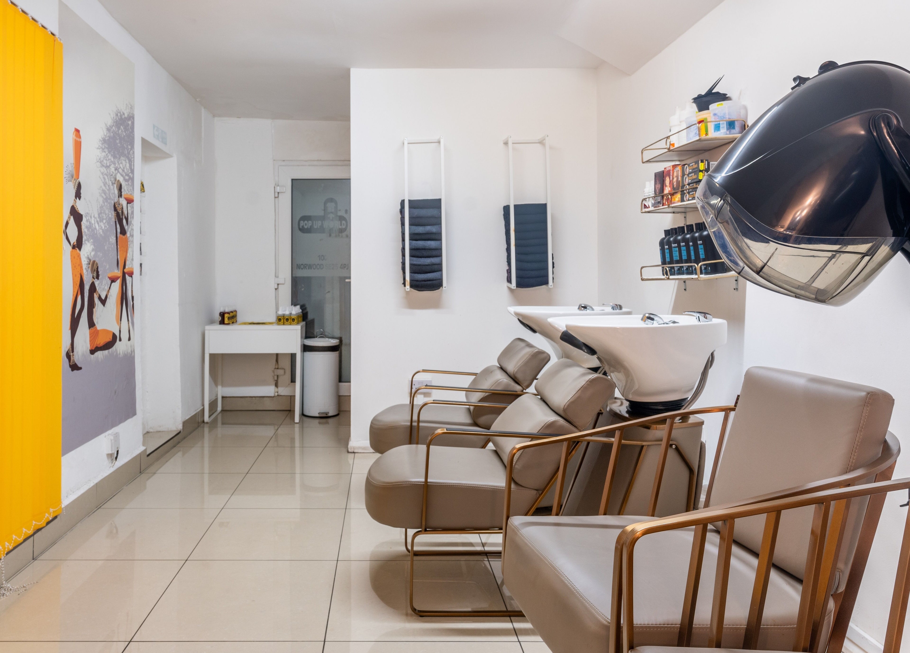 Interior of Locks & Style Studio, London, England, GB showcasing sleek hair stations and vibrant decor.