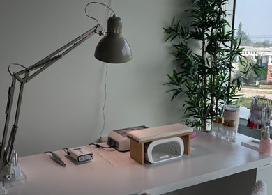 Manicure station at refine manicure studio in Surrey, British Columbia, CA with tools and greenery view.