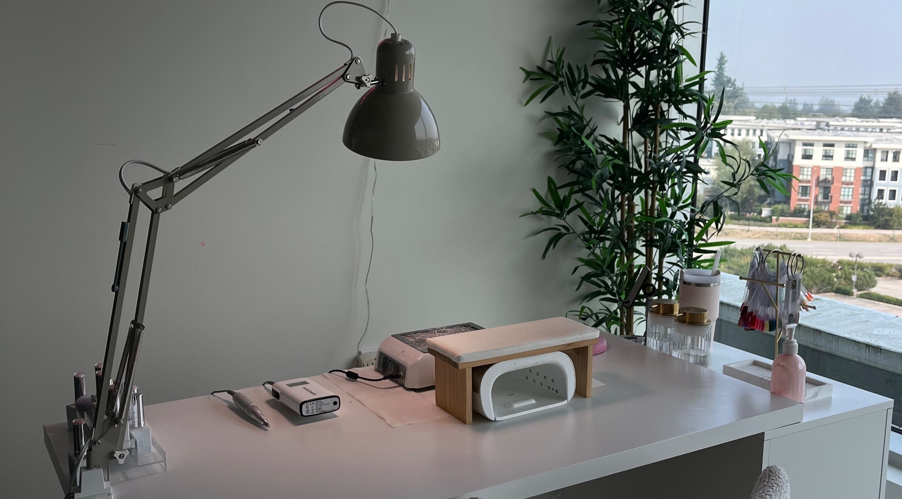 Manicure station at refine manicure studio in Surrey, British Columbia, CA with tools and greenery view.