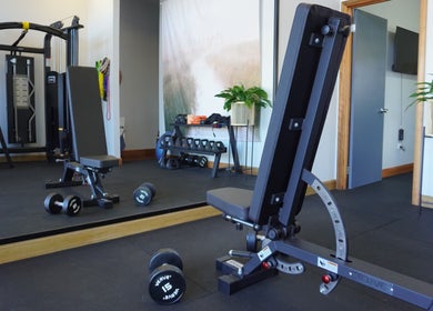 Modern fitness area at Studio You, Burnt Pine, NF with weights and equipment.