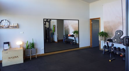 Spacious fitness area at Studio You in Burnt Pine, NF, featuring equipment and modern decor.