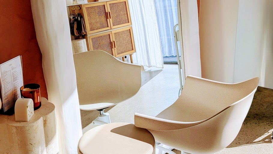 Cozy salon chairs at Lia Hanson Hair, Melbourne, Victoria, AU showcasing elegant interior details.
