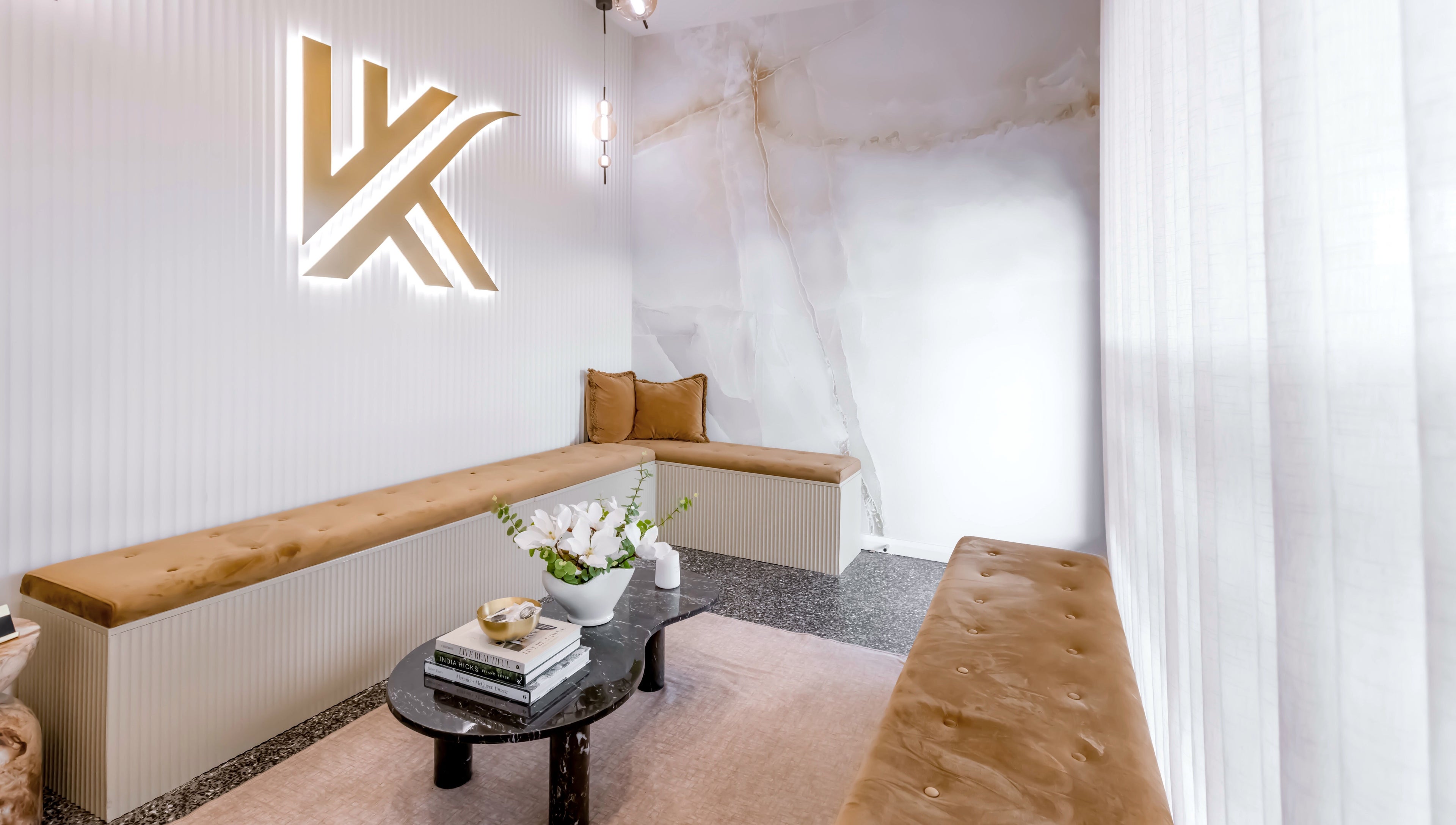 Stylish waiting area at Knockout Brows, Belmont, Victoria, AU with plush seating and chic decor.