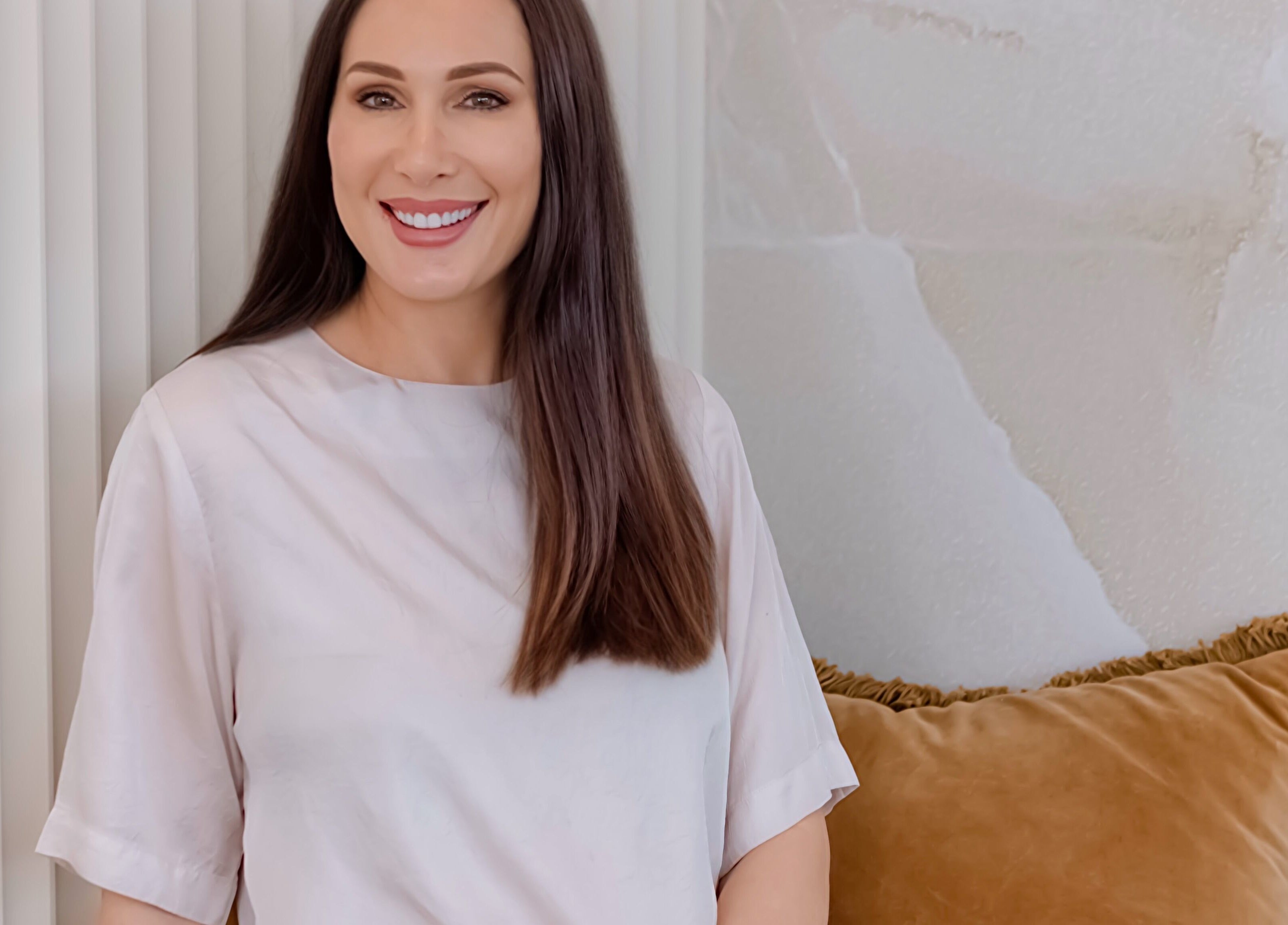 Professional smiling at Knockout Brows in Belmont, Victoria, AU with elegant decor.