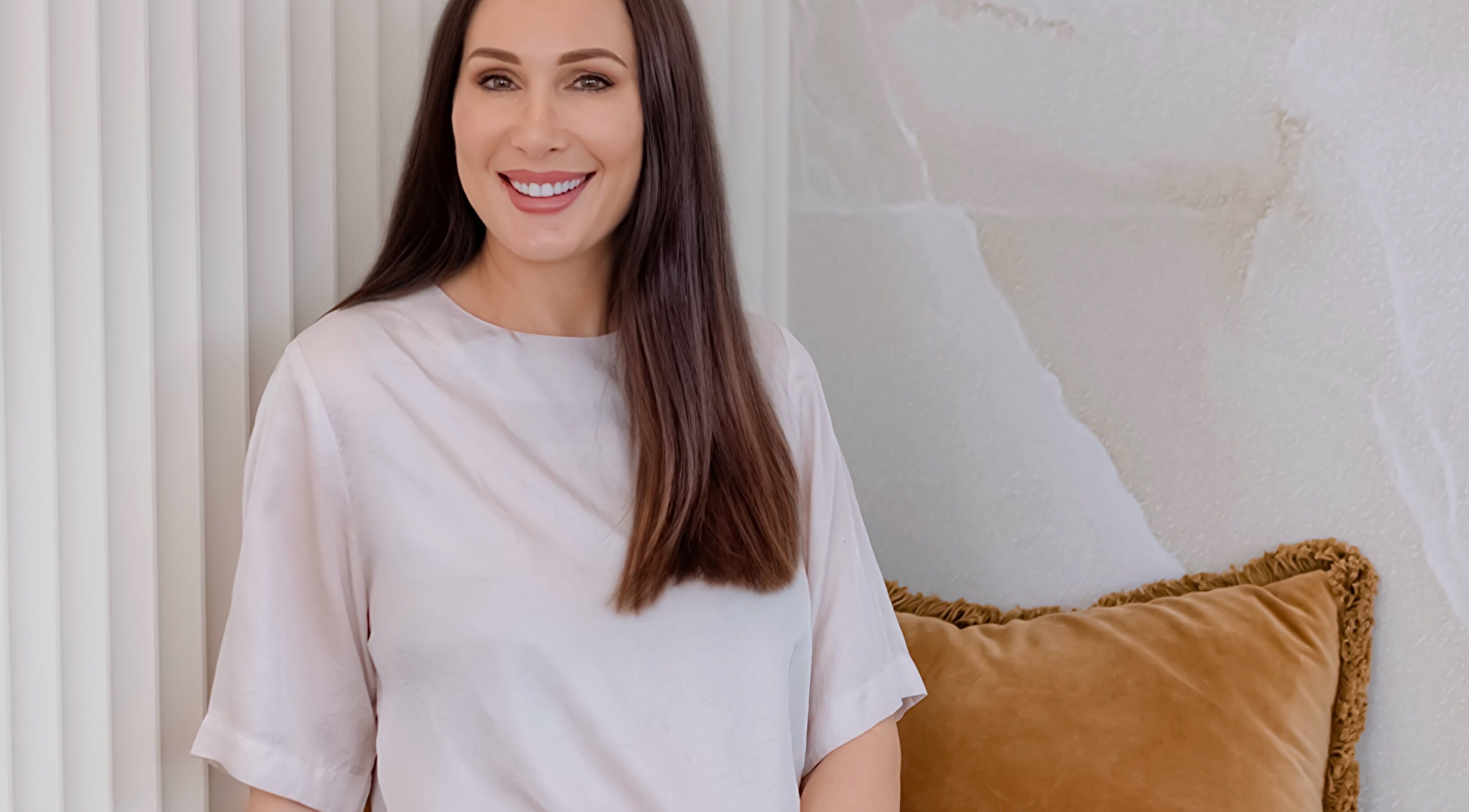 Professional smiling at Knockout Brows in Belmont, Victoria, AU with elegant decor.