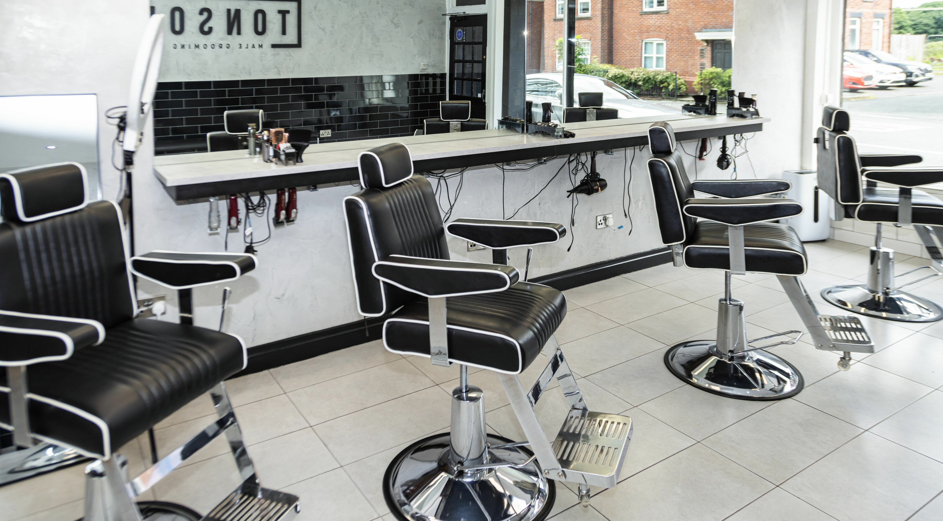 Modern barbershop chairs at Tonsor Male Grooming in Westhoughton, England, GB, ready for customers.